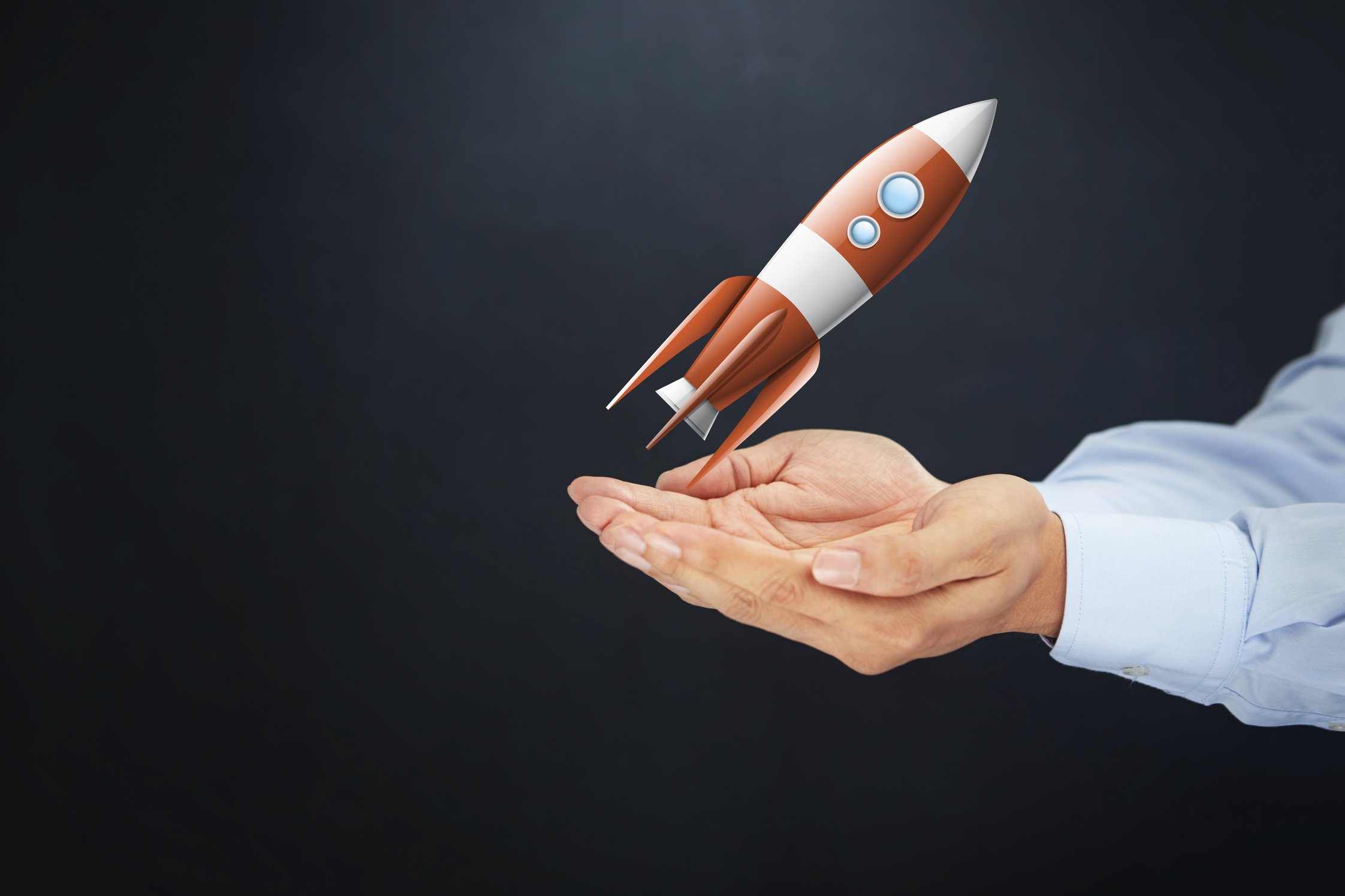 Hands presenting rocketship